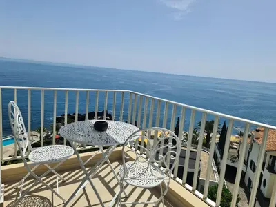a balcony with a table and chairs and the ocean at Step To The Sea 5, by Pausa Holiday Rentals in Funchal