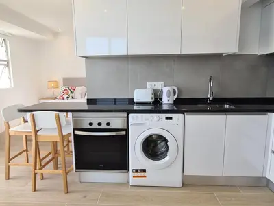 a kitchen with a washing machine and a sink at Step To The Sea 5, by Pausa Holiday Rentals in Funchal