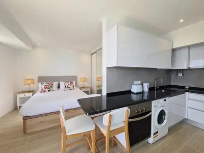a kitchen and bedroom with a bed and a table and chairs at Step To The Sea 5, by Pausa Holiday Rentals in Funchal