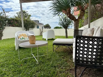 a patio with two chairs and a table and chairs at Oliveira's Home in Porto Santo