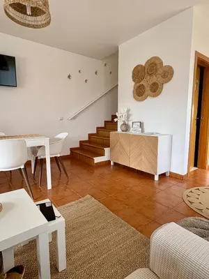 a living room with a couch and a table at Oliveira's Home in Porto Santo