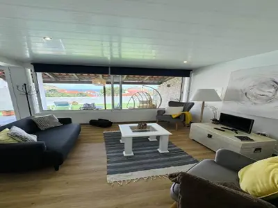 a living room with a couch and a table at Studio in Porto da Cruz with Ocean Views in Porto da Cruz