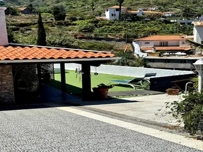 a roof of a house with a table and a chair at Studio in Porto da Cruz with Ocean Views in Porto da Cruz