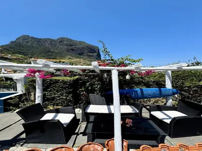 a deck with chairs and a pergola with a view at Studio in Porto da Cruz with Ocean Views in Porto da Cruz