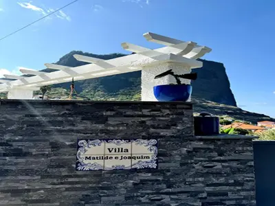 a building with a white pergola and a sign on it at Studio in Porto da Cruz with Ocean Views in Porto da Cruz