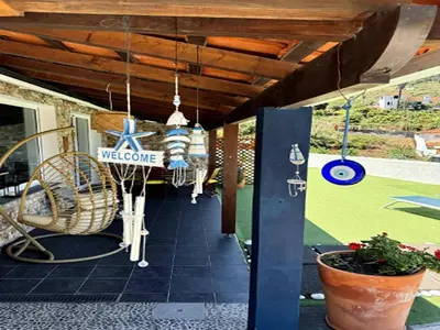 a living room with a table with a vase on it at Holiday home in Porto da Cruz with garden in Porto da Cruz