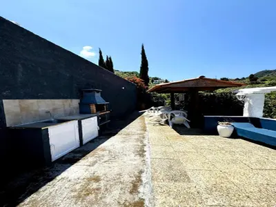 a patio with a sink and a table and a grill at Holiday home in Porto da Cruz with garden in Porto da Cruz