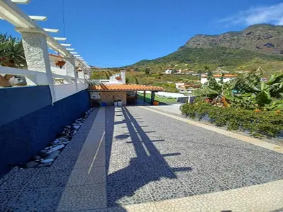 a shadow of a building with a mountain in the background at Villa in Porto da Cruz with Ocean Views in Porto da Cruz