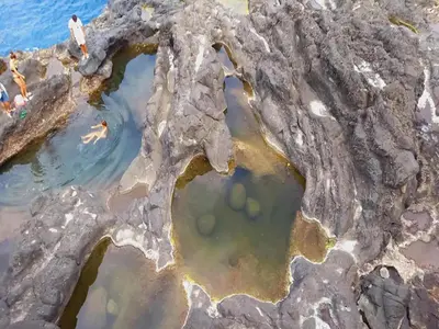 an aerial view of a pool of water in a rock quarry at Villa in Porto da Cruz with Ocean Views in Porto da Cruz