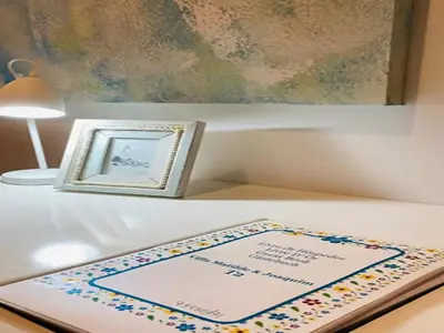 a birthday cake on a table next to a picture at Villa in Porto da Cruz with Ocean Views in Porto da Cruz