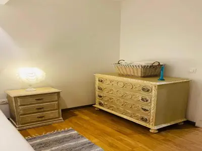 a bedroom with a dresser with a lamp on it at Villa in Porto da Cruz with Ocean Views in Porto da Cruz