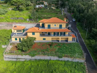 a large yellow house with an orange roof at Villa Nobrega by Holiday Rental Madeira in Funchal