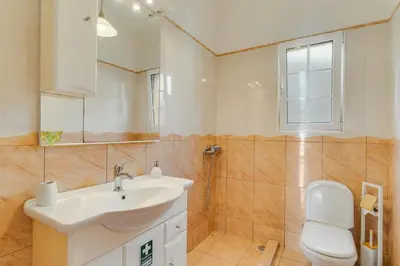 a bathroom with a sink and a toilet and a mirror at Villa Nobrega by Holiday Rental Madeira in Funchal