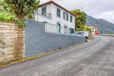 a house on the side of a road at Casa do Pinheiro I, a Home in Madeira in São Vicente
