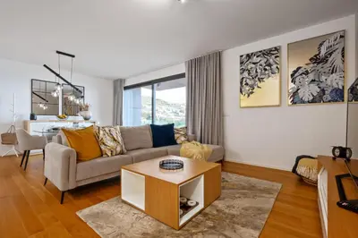 a living room with a couch and a table at Ajuda I - Penthouse by Pausa Holiday Rentals in Funchal