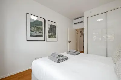a white bedroom with two towels on a bed at Ajuda I - Penthouse by Pausa Holiday Rentals in Funchal