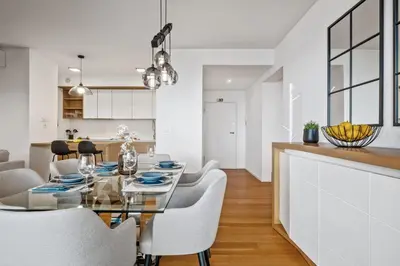 a dining room and kitchen with a glass table and chairs at Ajuda I - Penthouse by Pausa Holiday Rentals in Funchal