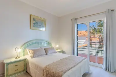 a bedroom with a bed and a large window at Alegria Apart. with Pool, by Pausa Holiday Rentals in Estreito da Calheta
