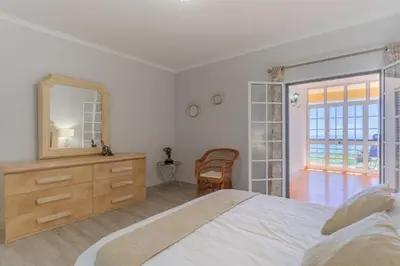 a bedroom with a bed and a mirror and a dresser at Alegria Apart. with Pool, by Pausa Holiday Rentals in Estreito da Calheta