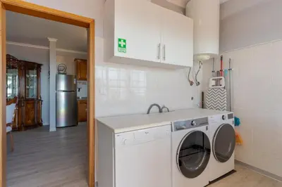 a kitchen with a washer and dryer in a room at Alegria Apart. with Pool, by Pausa Holiday Rentals in Estreito da Calheta