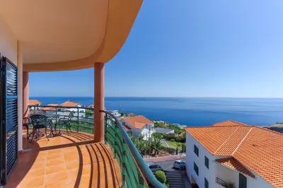 a balcony with a view of the ocean at Alegria Apart. with Pool, by Pausa Holiday Rentals in Estreito da Calheta