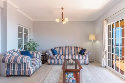 a living room with two chairs and a table at Alegria Apart. with Pool, by Pausa Holiday Rentals in Estreito da Calheta