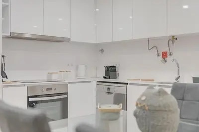 a kitchen with white cabinets and a counter top at Stay In Arriaga Avenue 09, by Pausa H. Rentals in Funchal