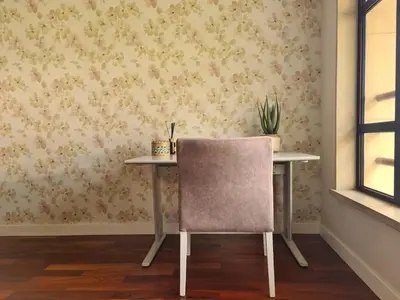 a table with a chair in a room with wallpaper at Stay In Arriaga Avenue 09, by Pausa H. Rentals in Funchal