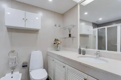 a white bathroom with a toilet and a sink at Stay In Arriaga Avenue 09, by Pausa H. Rentals in Funchal