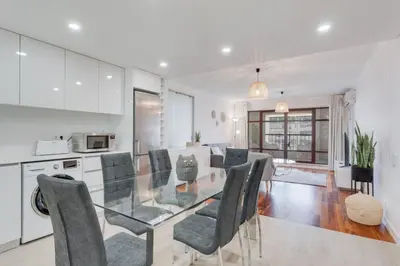a kitchen and dining room with a glass table and chairs at Stay In Arriaga Avenue 09, by Pausa H. Rentals in Funchal