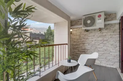 a balcony with a table and chairs and a window at Stay In Arriaga Avenue 09, by Pausa H. Rentals in Funchal