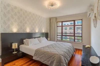 a bedroom with a large bed and a window at Stay In Avenue Arriaga 10, by Pausa H. Rentals in Funchal
