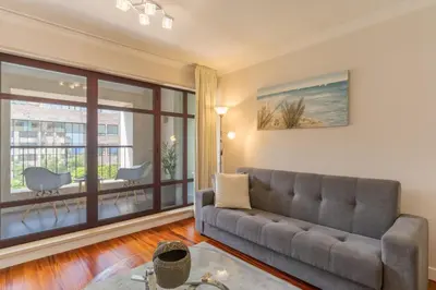 a living room with a couch and a large window at Stay In Avenue Arriaga 10, by Pausa H. Rentals in Funchal