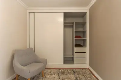 a dressing room with a chair and a mirror at Stay In Avenue Arriaga 10, by Pausa H. Rentals in Funchal