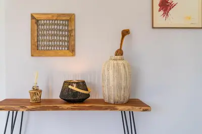 a wooden table with a vase on top of it at Stay In St. Catarina Park, by PAUSA H. Rentals in Funchal