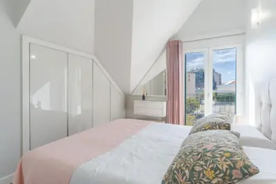 a white bedroom with a bed and a large window at Q.Vitória PentHouse, by Pausa Holiday Rentals in Funchal