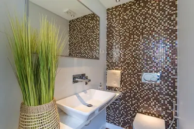a bathroom with a sink and a plant at Q.Vitória PentHouse, by Pausa Holiday Rentals in Funchal