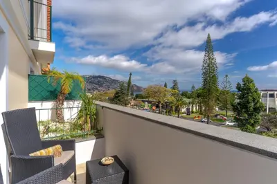a balcony with a view of a city at Q.Vitória PentHouse, by Pausa Holiday Rentals in Funchal