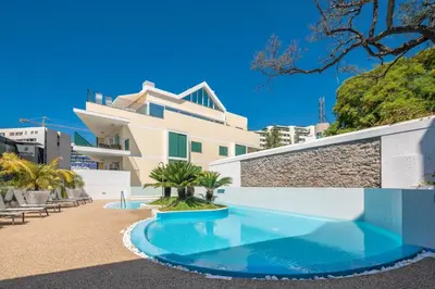 a swimming pool in front of a building at Q.Vitória PentHouse, by Pausa Holiday Rentals in Funchal