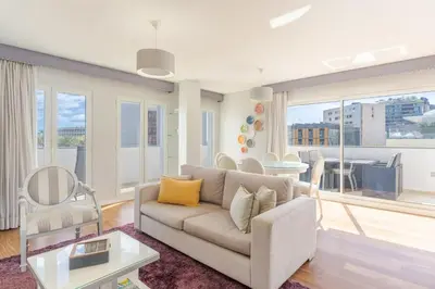 a living room with a couch and a table at Q.Vitória PentHouse, by Pausa Holiday Rentals in Funchal