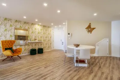 a living room with a white table and chairs at Renala I-Apart. 