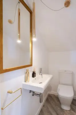 a bathroom with a white sink and a toilet at Renala I-Apart. 