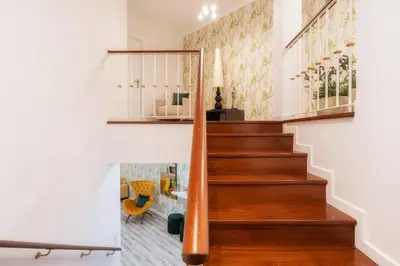 a staircase in a home with wood treads at Renala I-Apart. 