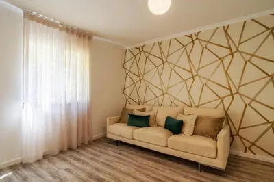 a living room with a couch against a wall at Renala I-Apart. 