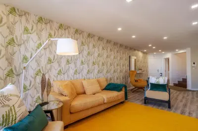 a living room with a couch and a chair at Renala I-Apart. 