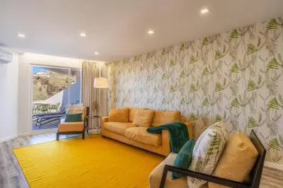 a living room with a couch and a chair at Renala I-Apart. 