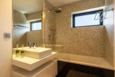 a bathroom with a sink and a tub and a mirror at Renala II - Apart, With Pool, by Pausa H. Rentals in Funchal