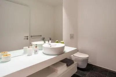 a white bathroom with a sink and a toilet at Renala II - Apart, With Pool, by Pausa H. Rentals in Funchal