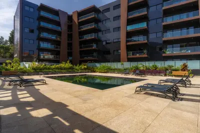 a pool in front of a building with benches at Renala II - Apart, With Pool, by Pausa H. Rentals in Funchal