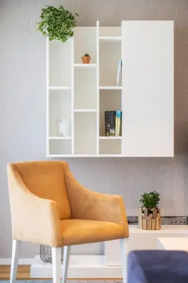 an orange chair in a room with a white cabinet at Renala II - Apart, With Pool, by Pausa H. Rentals in Funchal